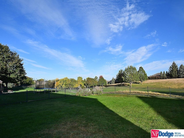 view of yard featuring a rural view and a trampoline