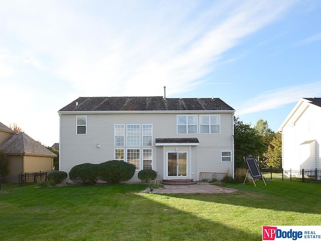 rear view of property with a yard and a patio area