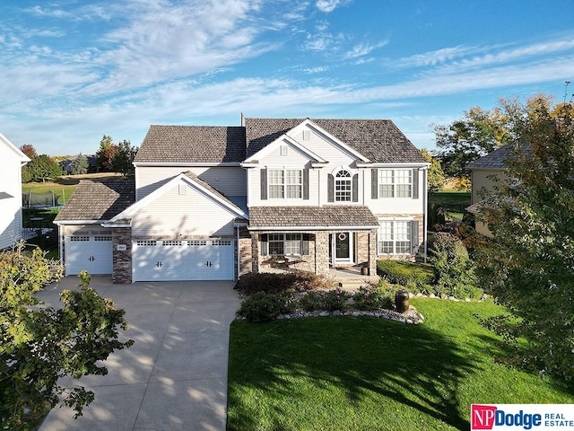 front of property featuring a front yard and a garage