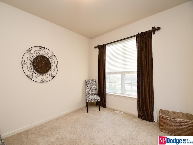 living area with light colored carpet