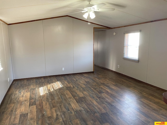 empty room with ceiling fan, lofted ceiling, dark hardwood / wood-style floors, and crown molding