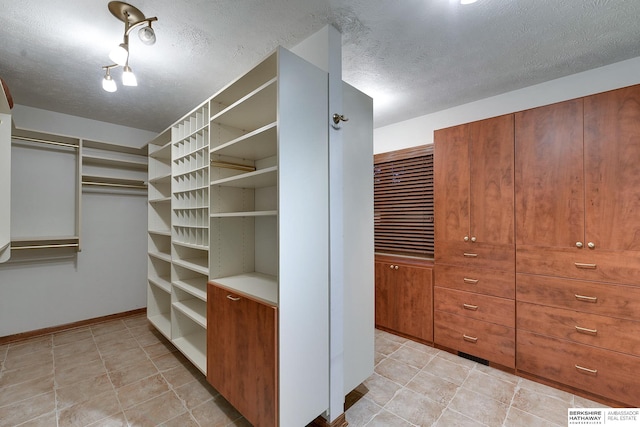 walk in closet with light tile patterned flooring