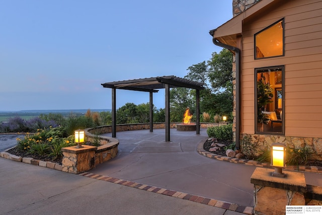 patio terrace at dusk featuring a pergola