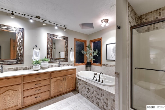 bathroom with vanity, tile patterned floors, a textured ceiling, and plus walk in shower