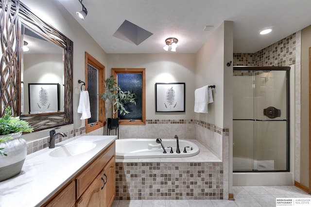 bathroom with vanity, a textured ceiling, independent shower and bath, and tile patterned floors