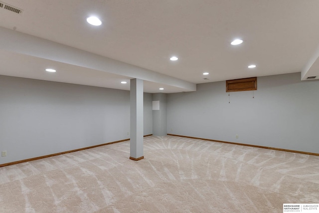 basement featuring light carpet