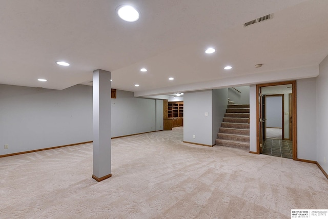 basement featuring light carpet