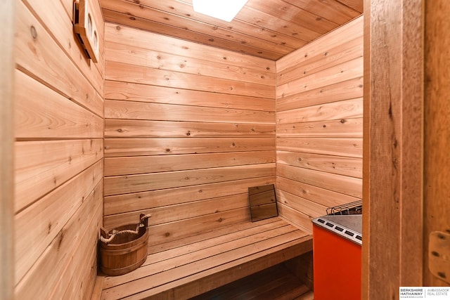 view of sauna featuring wooden walls and wooden ceiling