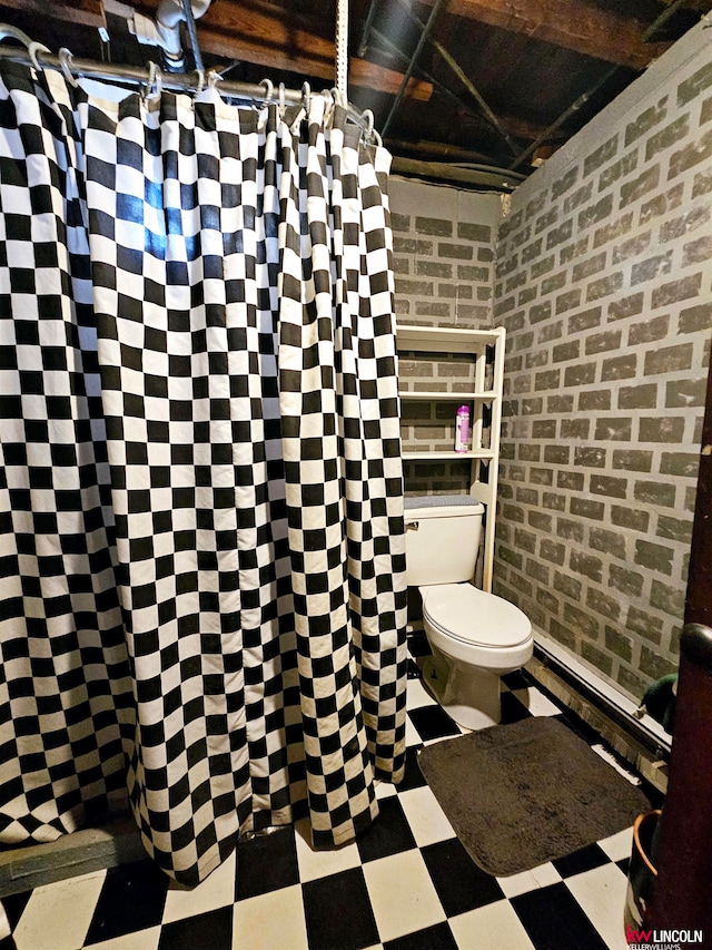 bathroom with brick wall, a shower with curtain, and toilet