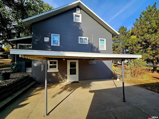 back of property with a carport