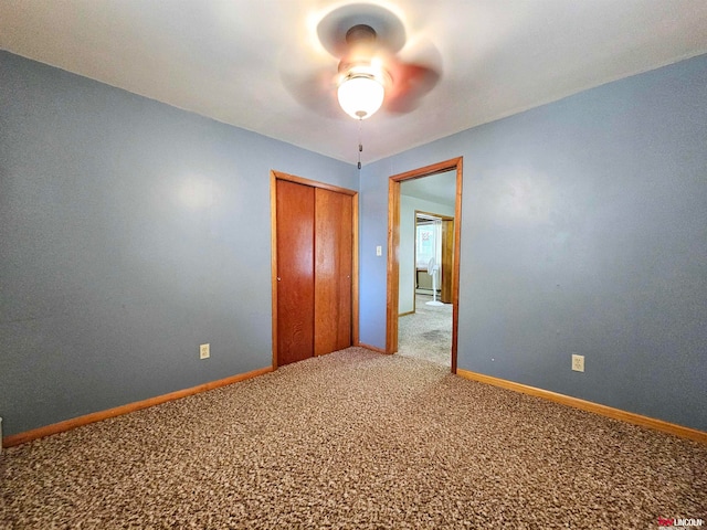 unfurnished bedroom featuring carpet floors, a closet, and ceiling fan