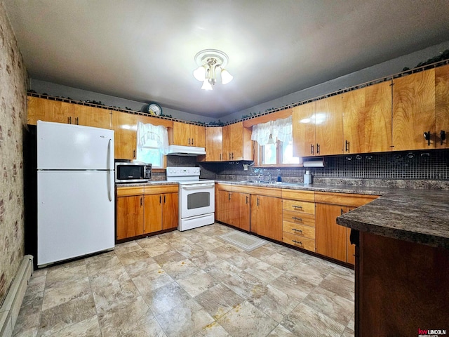 kitchen with backsplash and white appliances