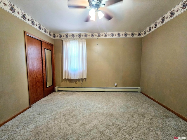 unfurnished bedroom featuring ceiling fan, carpet floors, a closet, and a baseboard heating unit