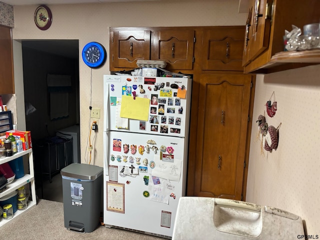 kitchen featuring white fridge and light carpet