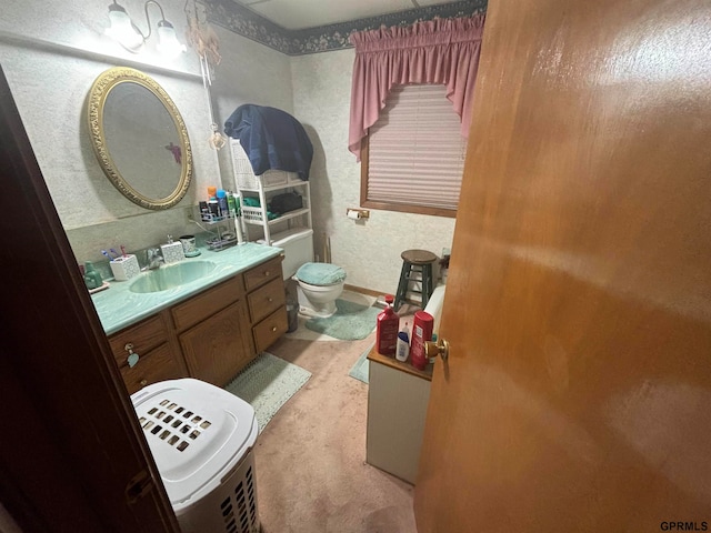 bathroom featuring toilet and vanity