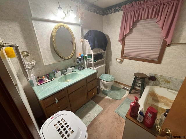 bathroom with vanity, toilet, and a washtub