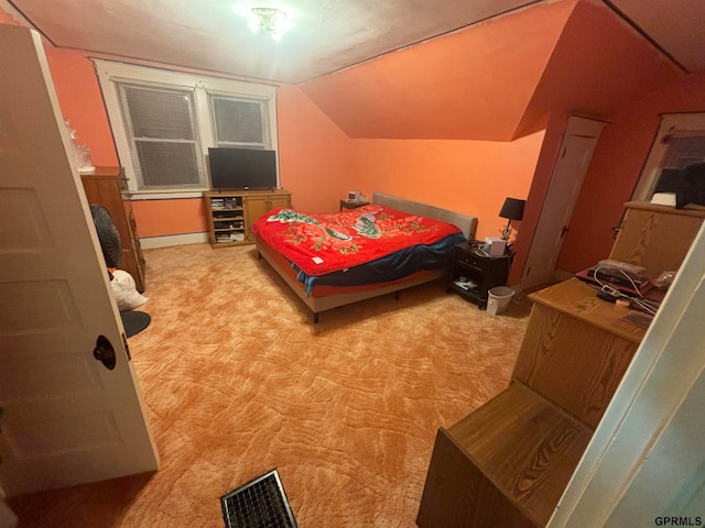 bedroom featuring vaulted ceiling and light carpet