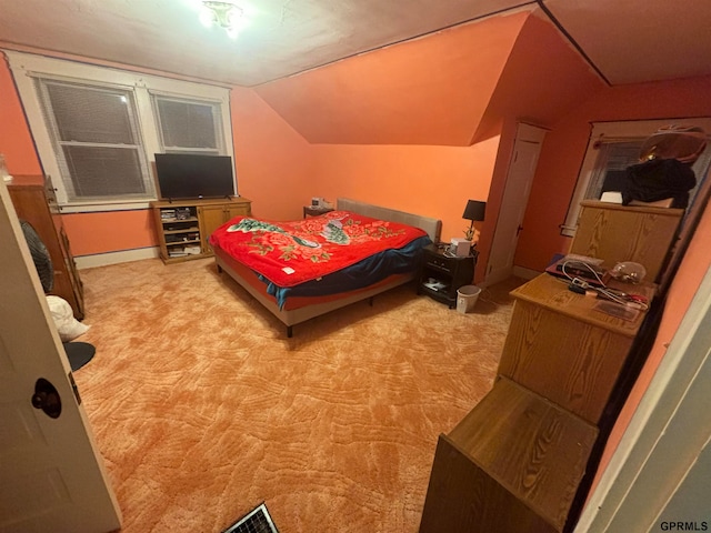 bedroom with light carpet and vaulted ceiling