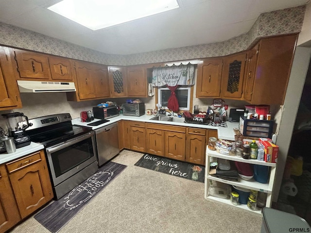 kitchen with stainless steel appliances, light colored carpet, and sink