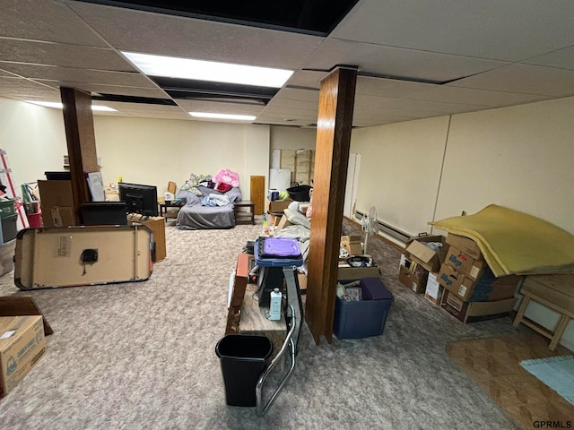 basement featuring a drop ceiling and carpet flooring