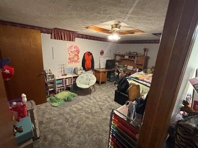 carpeted bedroom featuring a tray ceiling, a textured ceiling, and ceiling fan