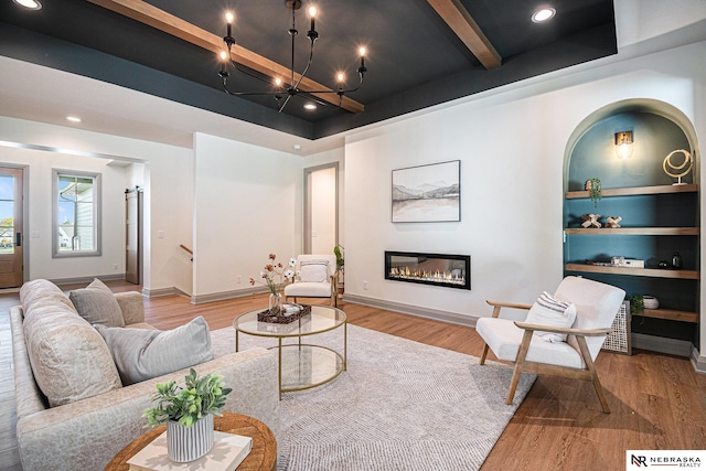 living room featuring a tray ceiling, beam ceiling, and light hardwood / wood-style flooring