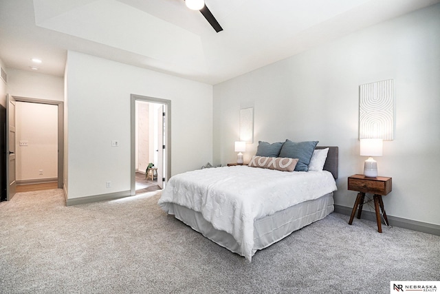 carpeted bedroom featuring ensuite bath and ceiling fan