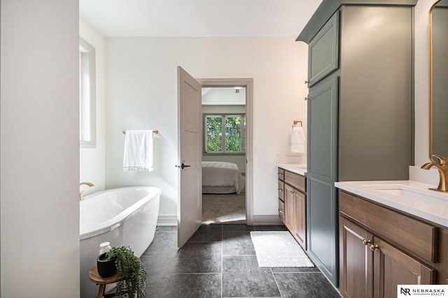 bathroom with a tub and vanity