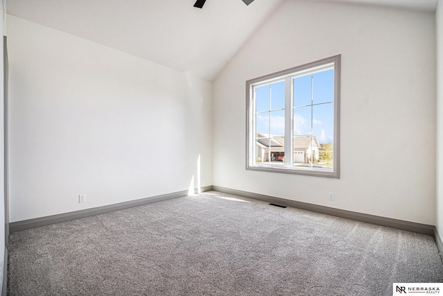 carpeted empty room with ceiling fan and vaulted ceiling