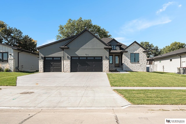 view of front of property with a garage and a front lawn