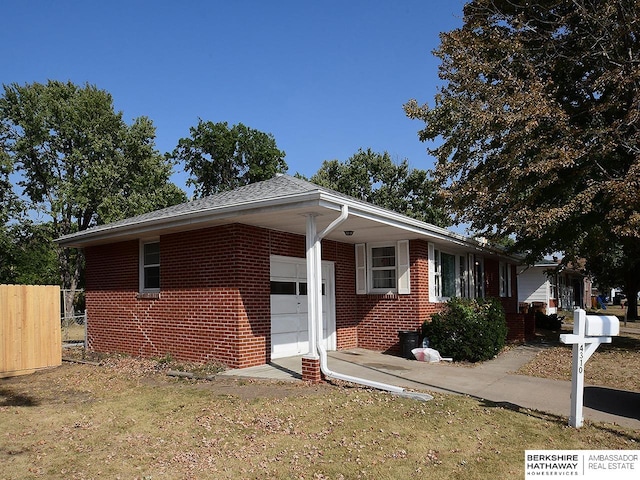 view of front of property with a front lawn and a garage