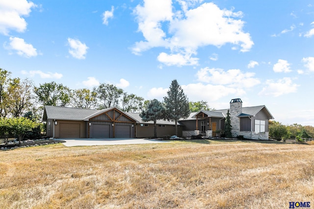 ranch-style home featuring a garage and a front lawn