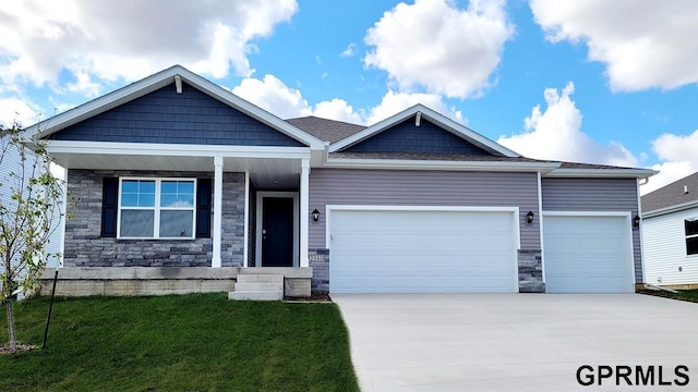 craftsman-style house featuring a front yard and a garage