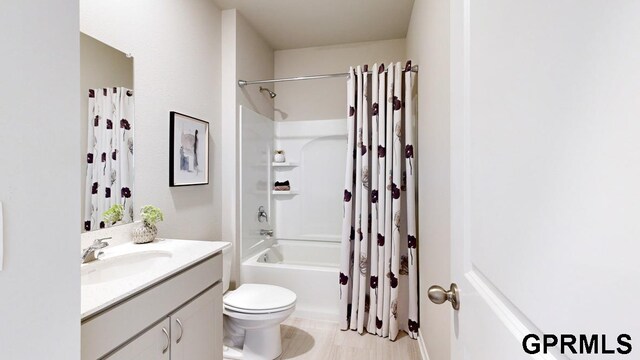 full bathroom featuring vanity, toilet, and shower / tub combo with curtain