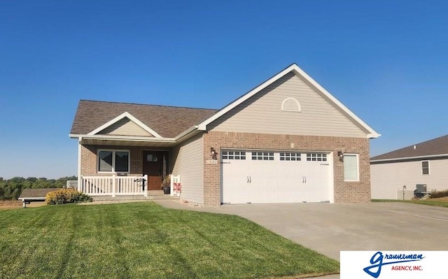 view of front of property with a porch, a front yard, and a garage