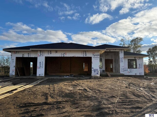 unfinished property featuring an attached garage