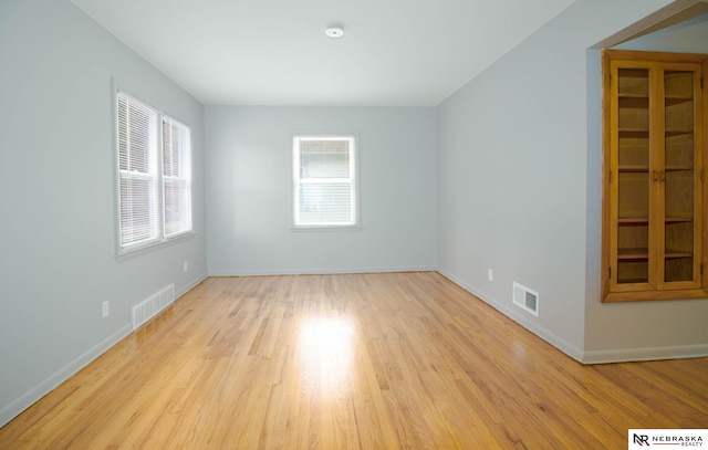 unfurnished room with light wood-type flooring