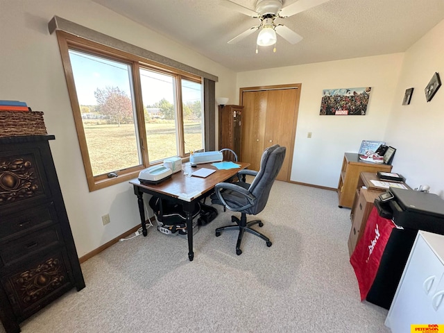 office area featuring light carpet and ceiling fan