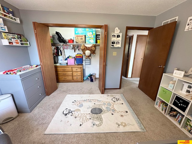 carpeted bedroom featuring a textured ceiling and a closet