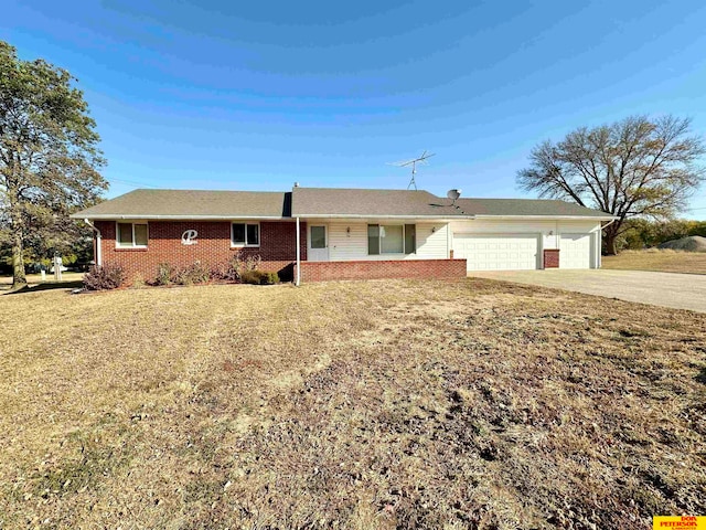 ranch-style home with a front yard and a garage