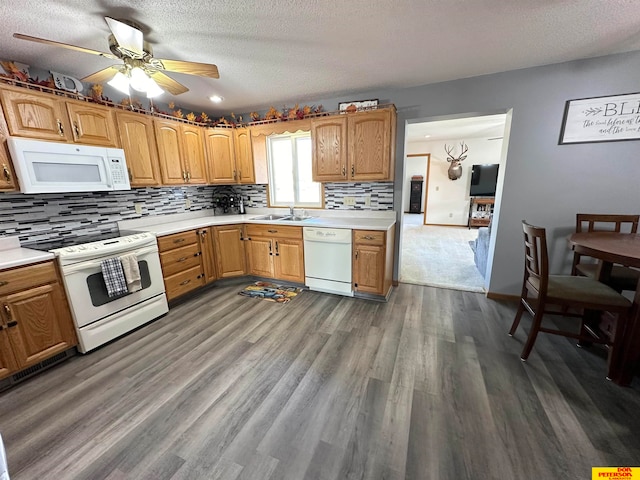 kitchen with sink, dark hardwood / wood-style flooring, a textured ceiling, white appliances, and ceiling fan