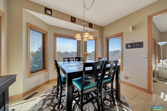 tiled dining area with an inviting chandelier