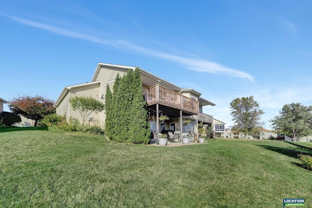 rear view of house with a yard and a deck