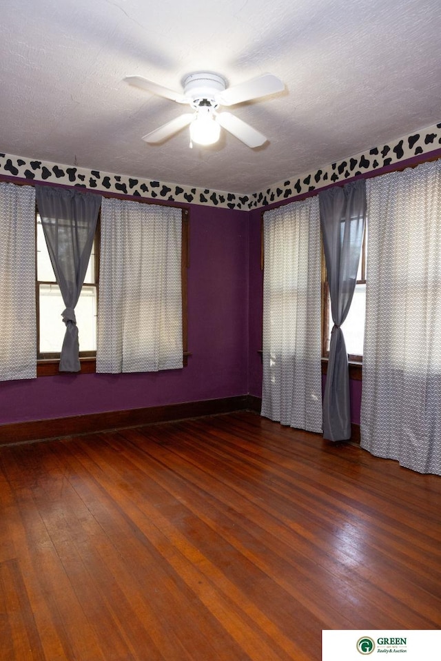 empty room featuring ceiling fan, a textured ceiling, and hardwood / wood-style floors