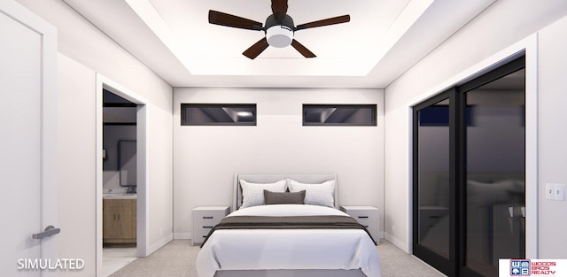 bedroom featuring connected bathroom, light colored carpet, a tray ceiling, and ceiling fan