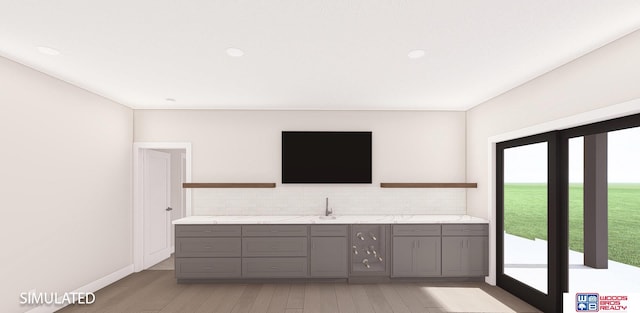 interior space with vanity, hardwood / wood-style floors, and tasteful backsplash