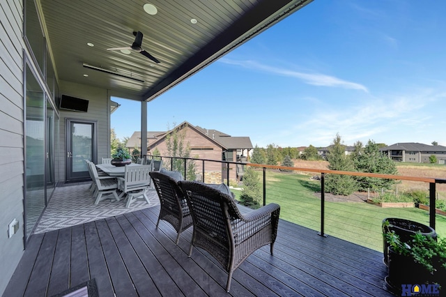 deck featuring a lawn and ceiling fan