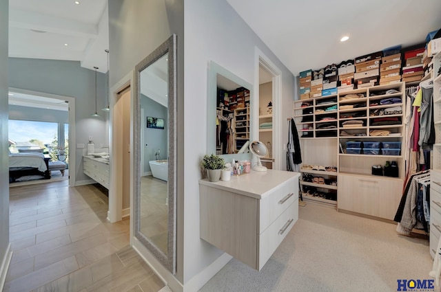 walk in closet with vaulted ceiling