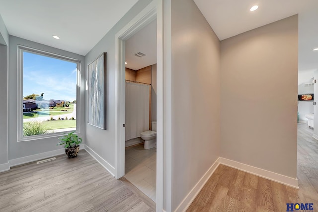 hall with light hardwood / wood-style floors