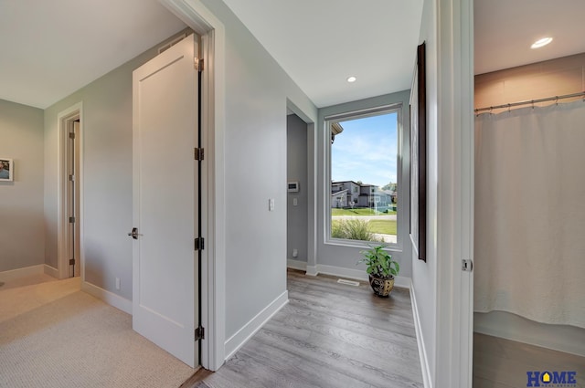 hallway with light wood-type flooring